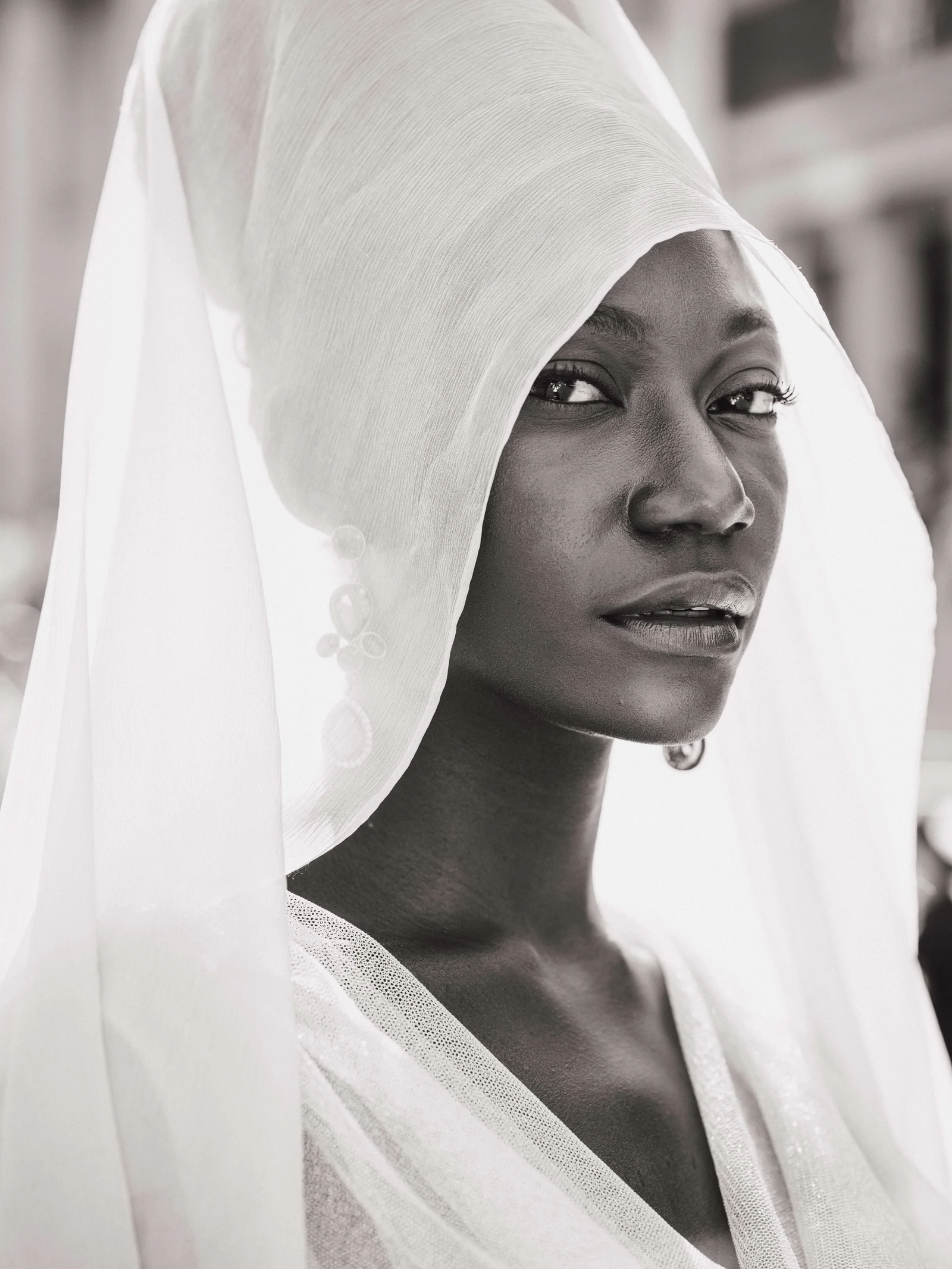 Alexis Monsanto — Black-and-white portrait of a model framed by a white sculptural veil
