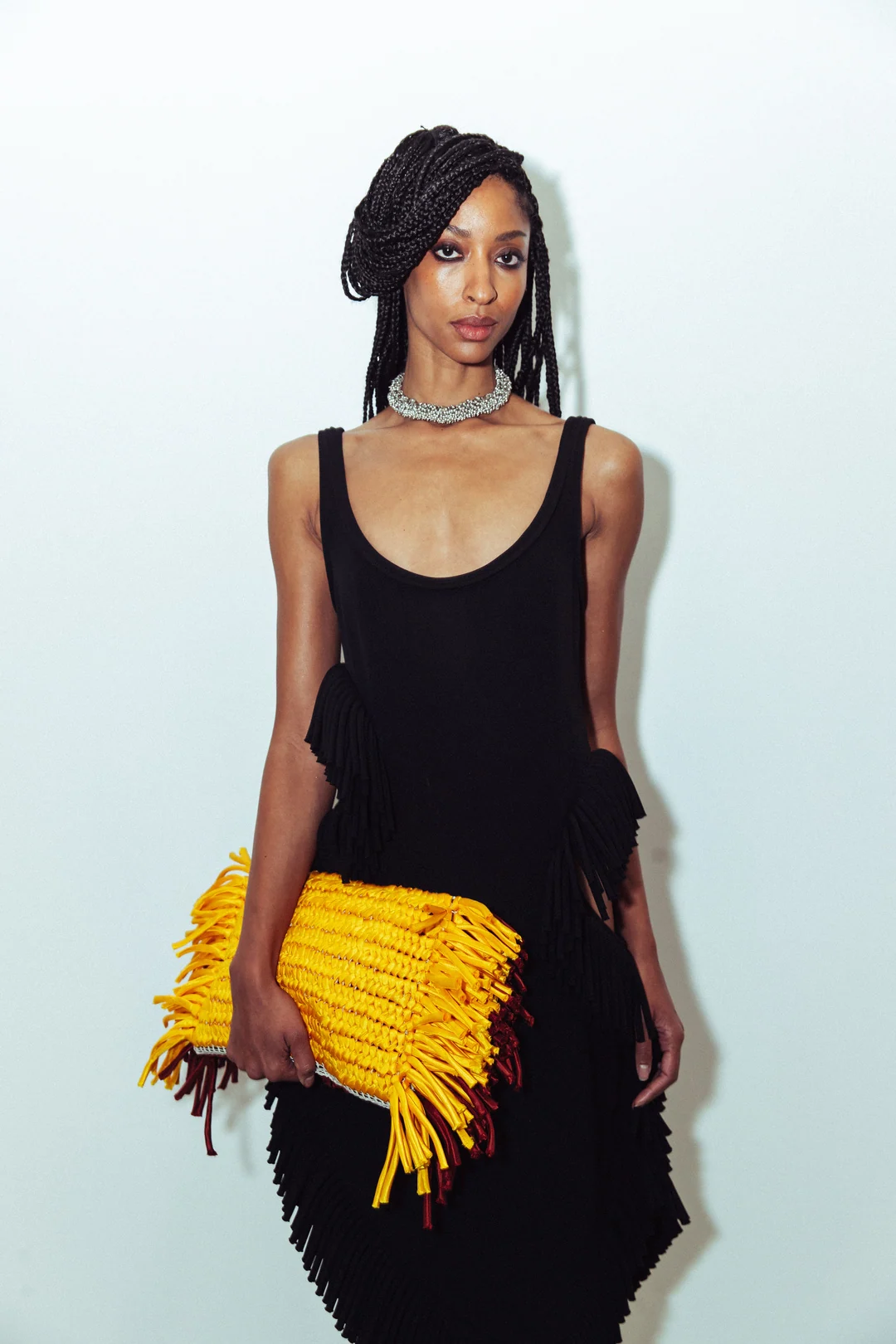 Diotima — A model wearing a beret and a sculptural fringed skirt