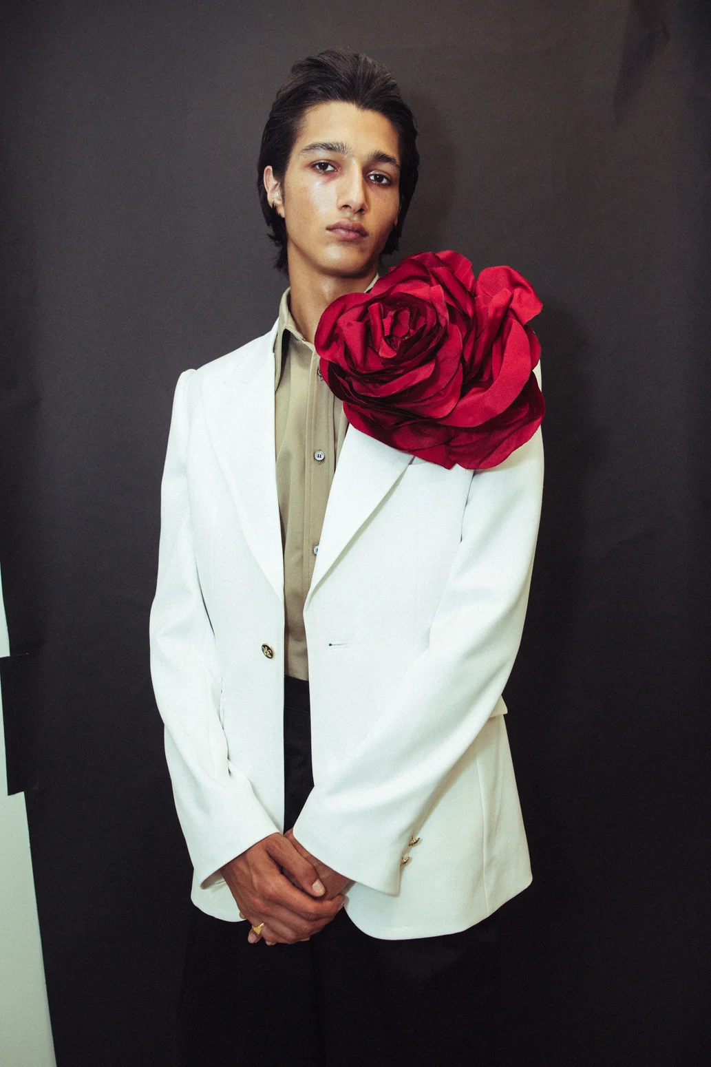 Willy Chavarria — A model in a pale suit with a sculptural rose detail