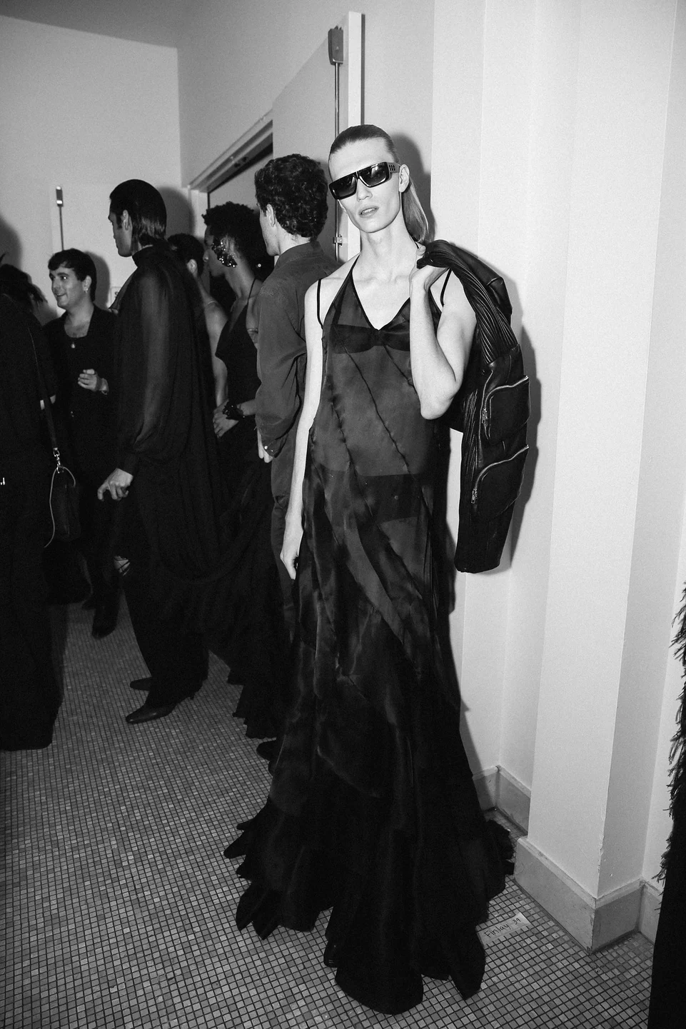 Palomo Spain — A model in a flowing dark gown backstage