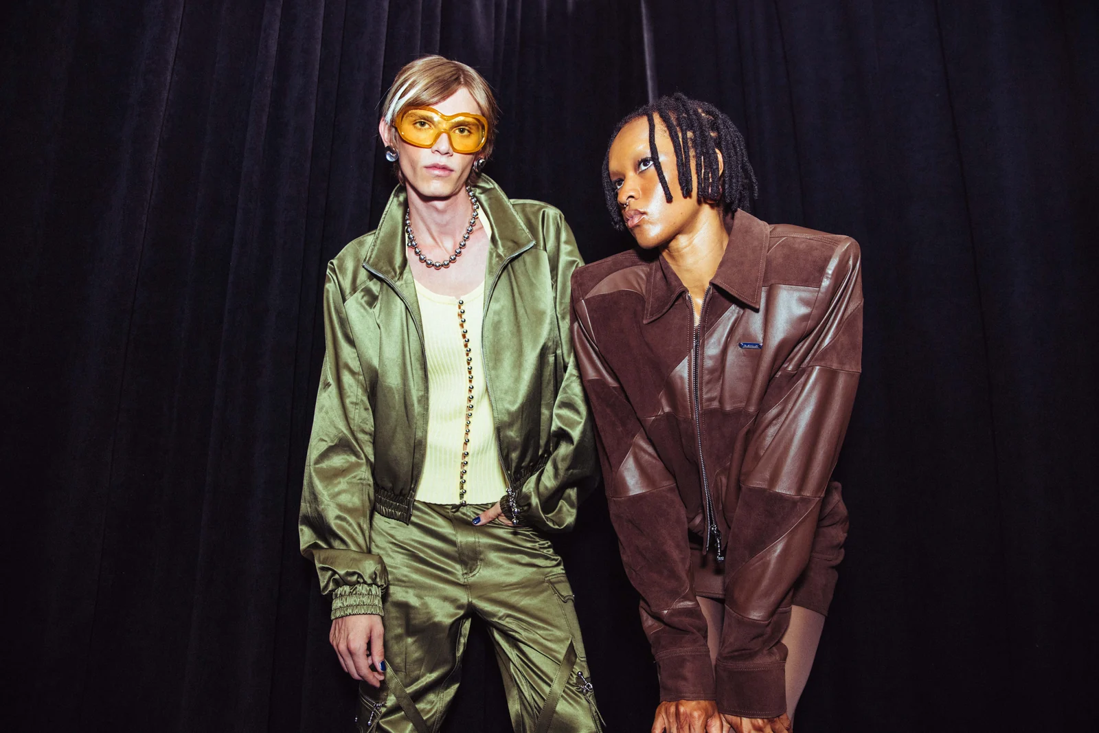 Private Policy — Two models in olive and brown leather looks backstage